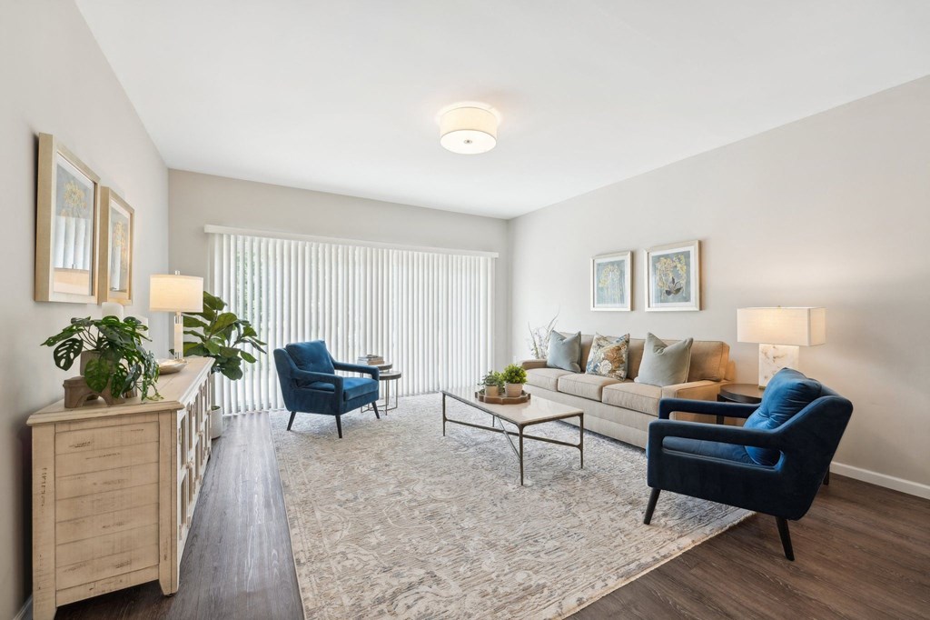 a living room with a couch and two blue chairs