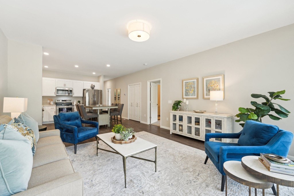 a living room with blue chairs and a table