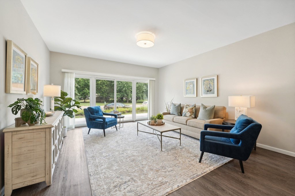 spacious living room with blue chairs and a couch