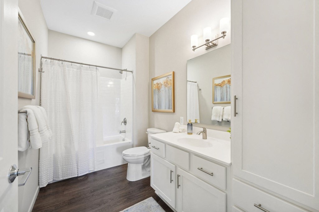 a bathroom with a large mirror and a lot of storage