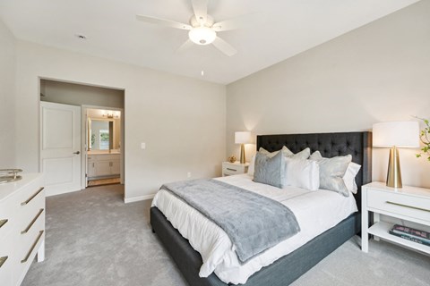 a bedroom with a bed and a ceiling fan