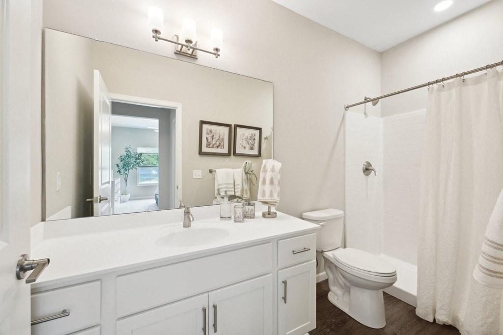 ensuite bathroom with a large mirror and walk-in shower