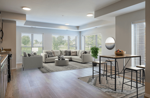 A modern living room with a large sectional sofa and a coffee table.