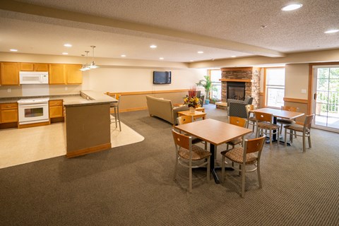 A spacious kitchen and dining area with a television mounted above the fireplace.