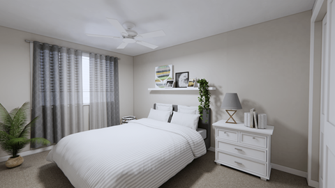A bedroom with a white bed and a white dresser with a plant on top.