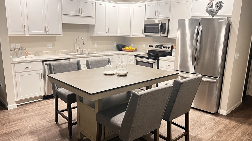 Kitchen with stainless steel appliances and a plenty of room for a table and chairs