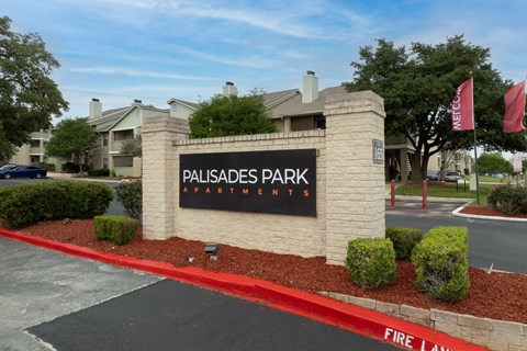 The entrance to Palisades Park Apartments is marked by a large sign.