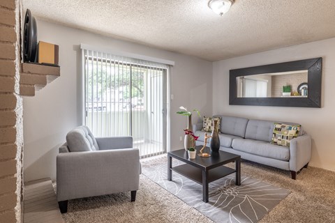 a living room with a couch and a chair and a table