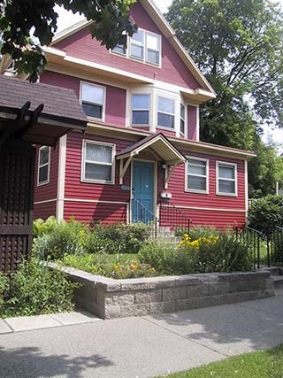 A red house with a blue door and windows.