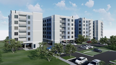 A modern apartment complex with a parking lot in front.