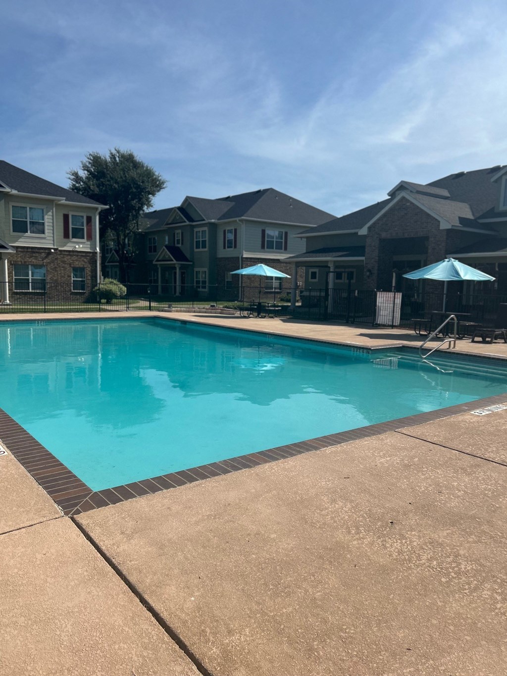a swimming pool with apartment buildings in the background