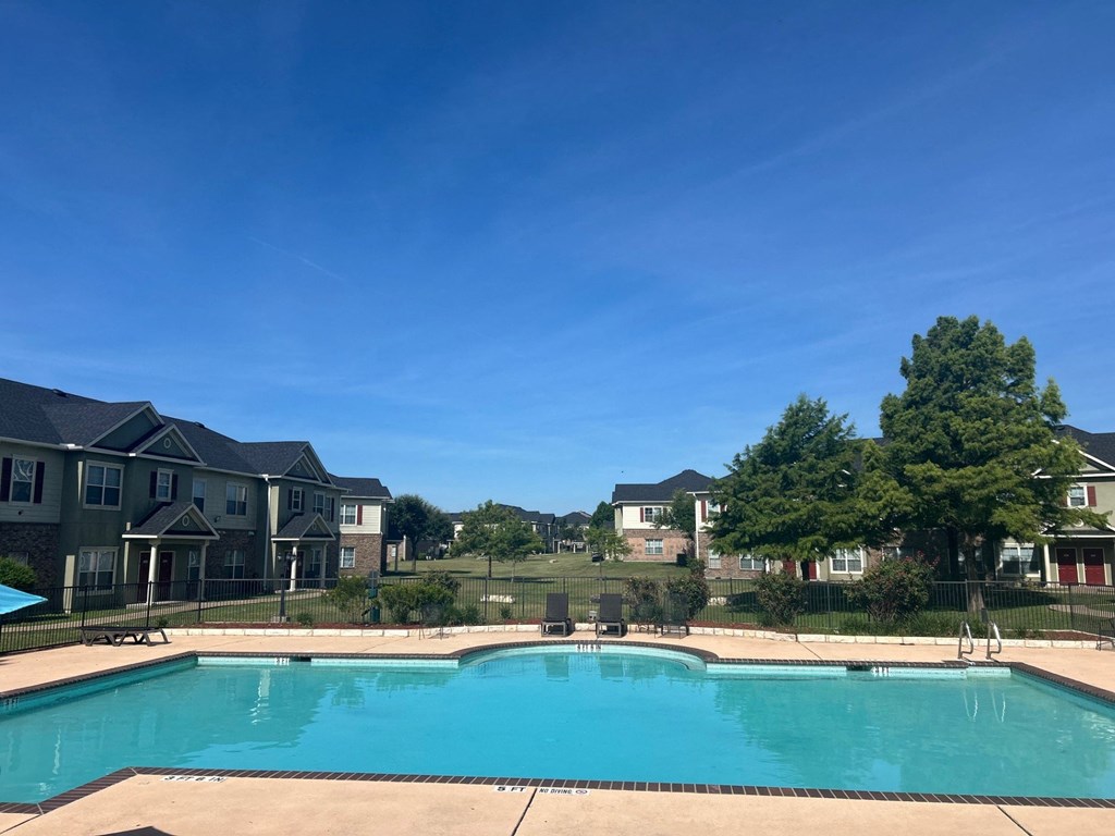 a swimming pool with houses in the background