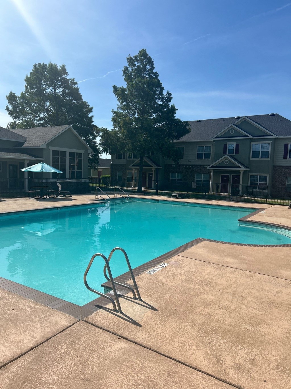 a swimming pool with a building in the background