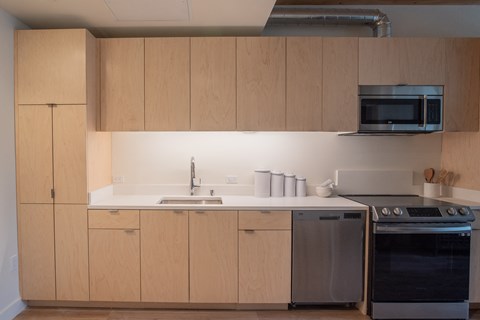 a kitchen with wooden cabinets and a sink and a stove