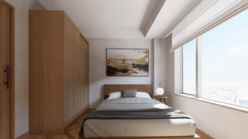 a small bedroom with a bed and a large window