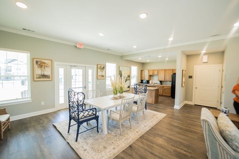 a dining room with a white table and chairs