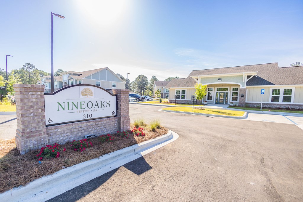 the entrance to nines oaks sign in front of a building