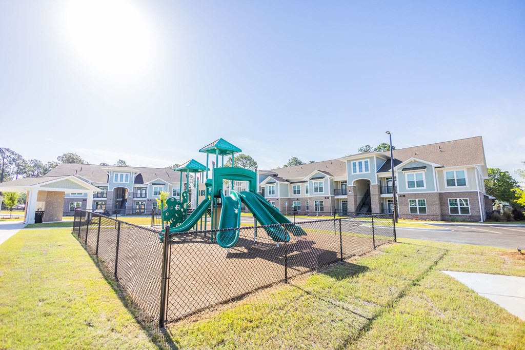 the preserve at ballantyne commons playground with play equipment and apartments in the background
