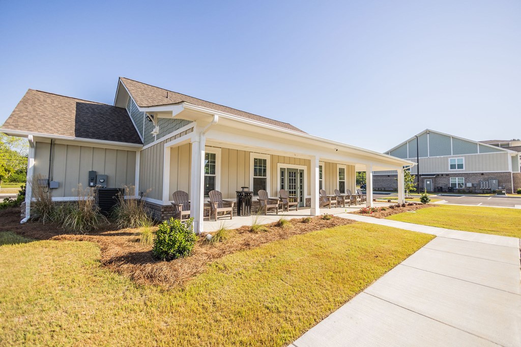 the preserve at ballantyne commons community clubhouse with patio and grass