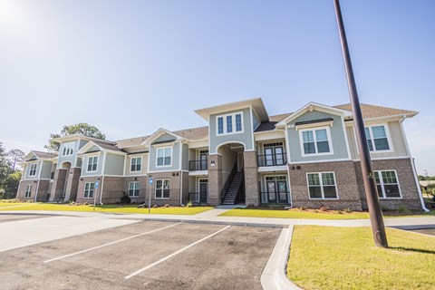 an apartment building with an empty parking lot