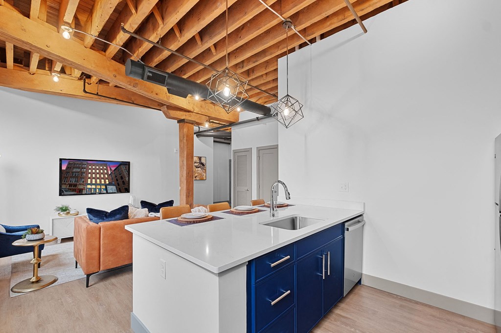 a kitchen with blue cabinets and a white counter top