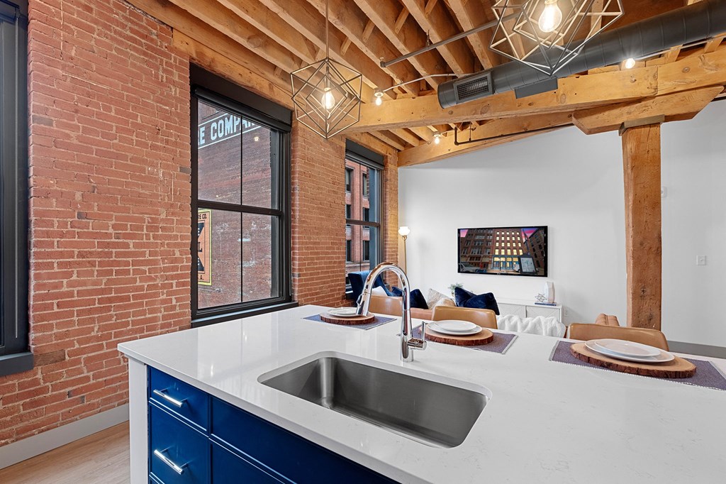 a kitchen with a sink and a large window