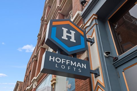 A sign for Hoffman Lofts is displayed on a building.