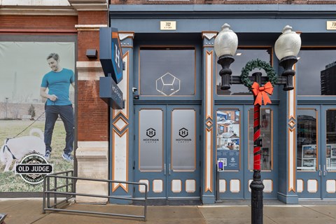 A storefront with a blue door and a sign that says "OLD JUDGE".