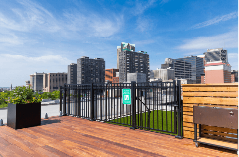 the deck has a bench and a view of the city