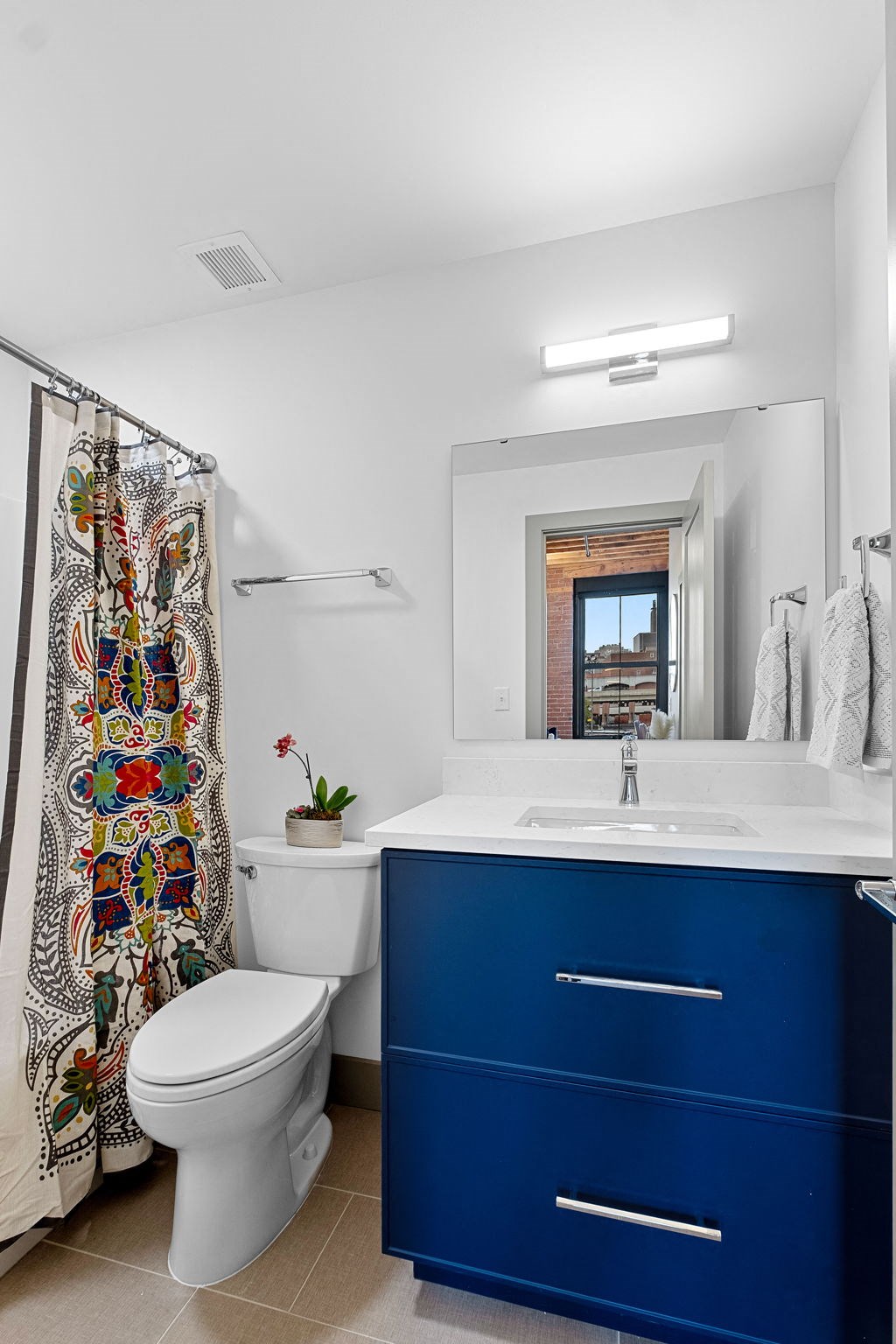 a blue and white bathroom with a toilet and a sink