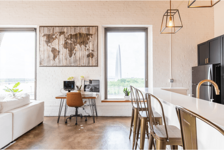the kitchen and dining area of a loft apartment