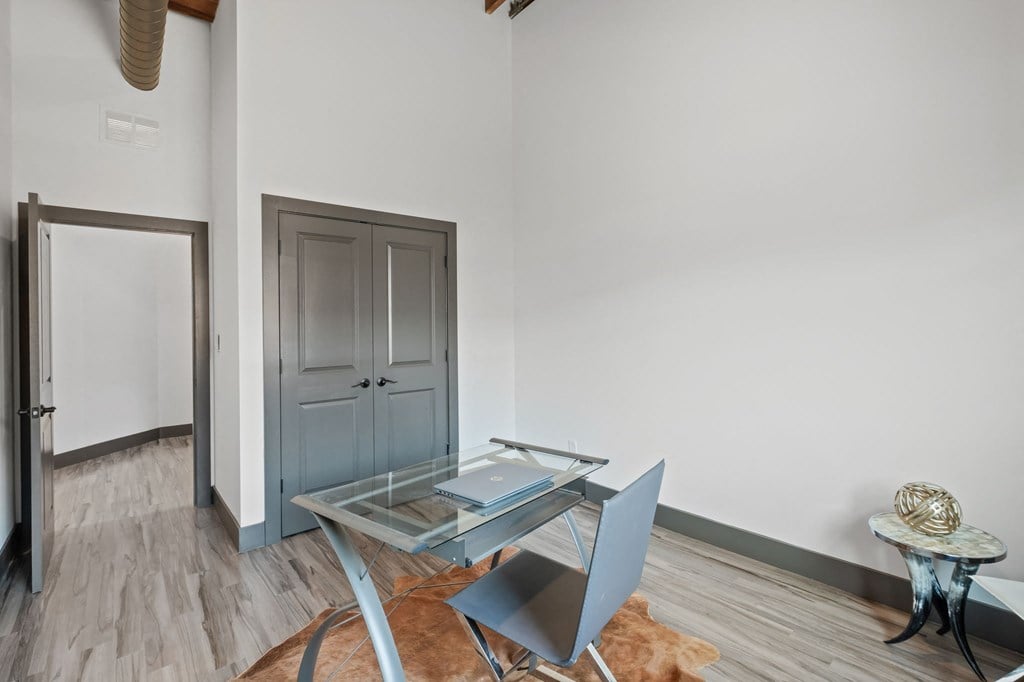 a dining room with a glass table and chairs
