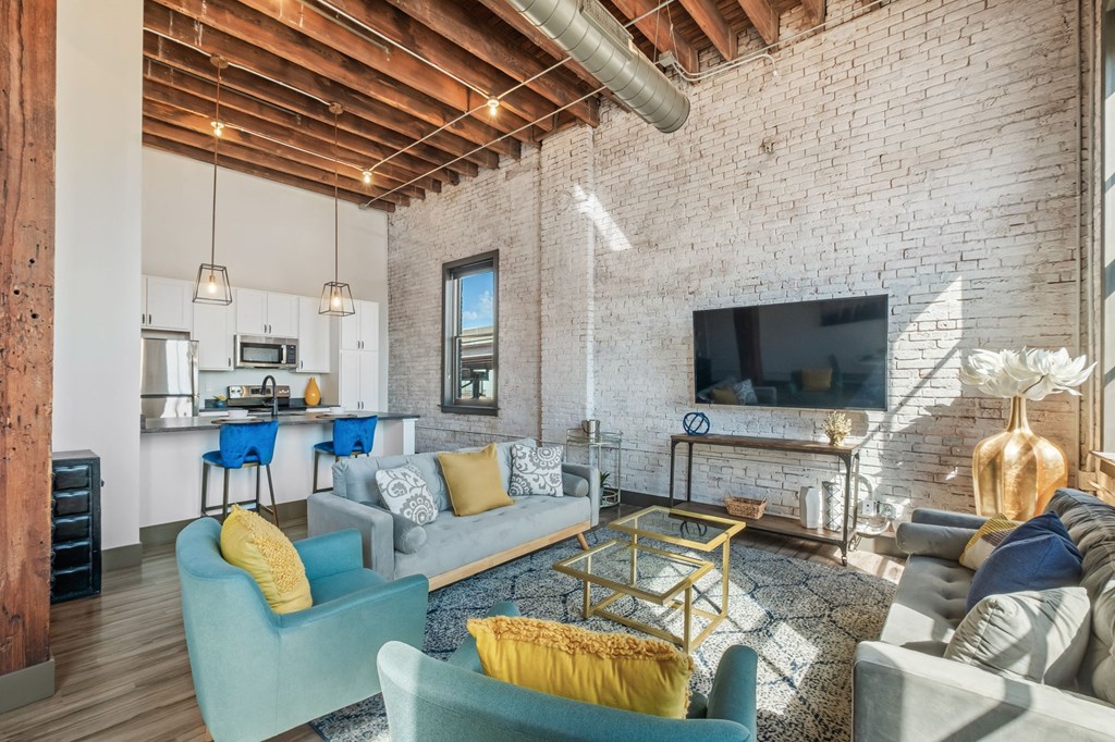 a living room with couches and chairs and a tv