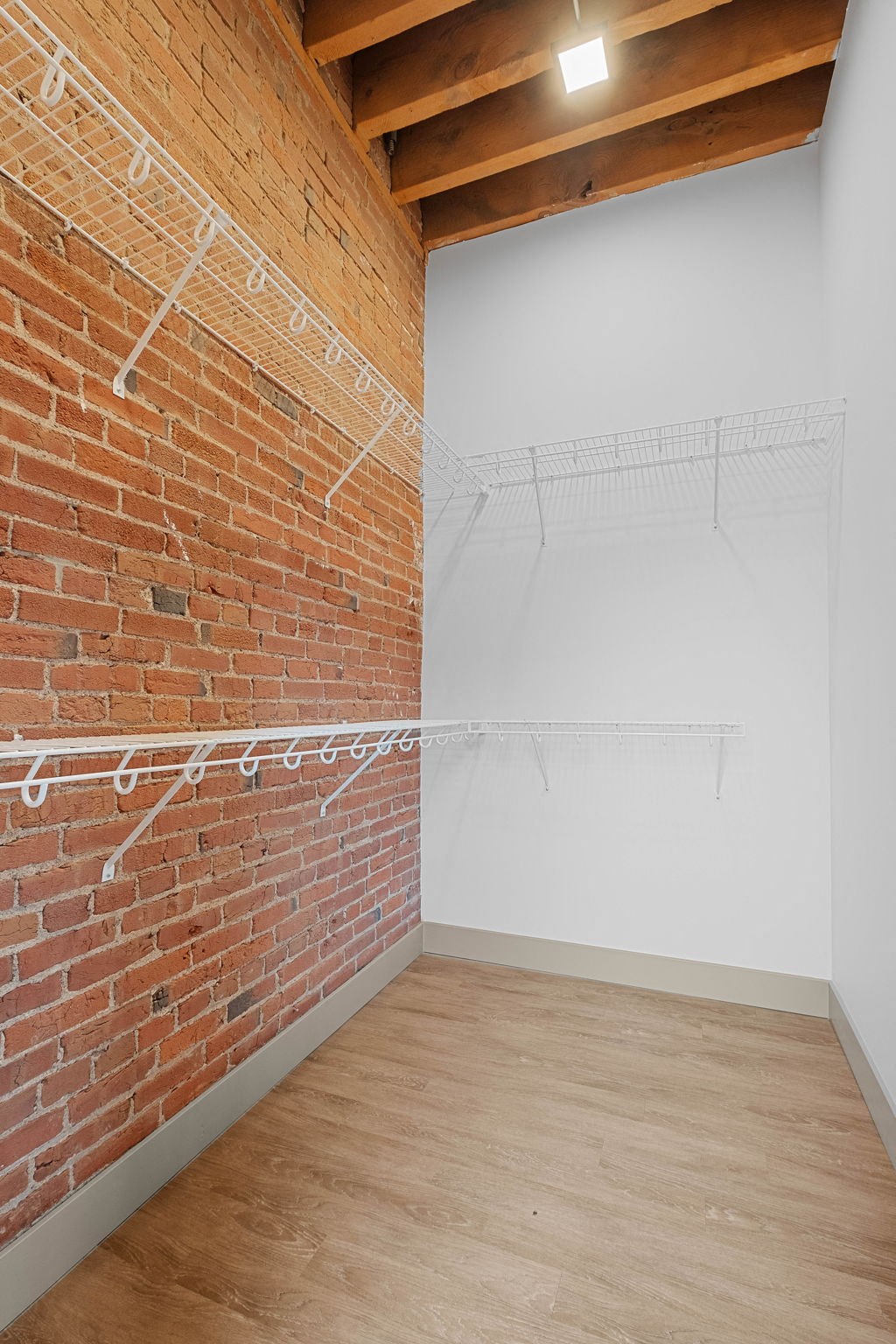a room with a brick wall and white walls