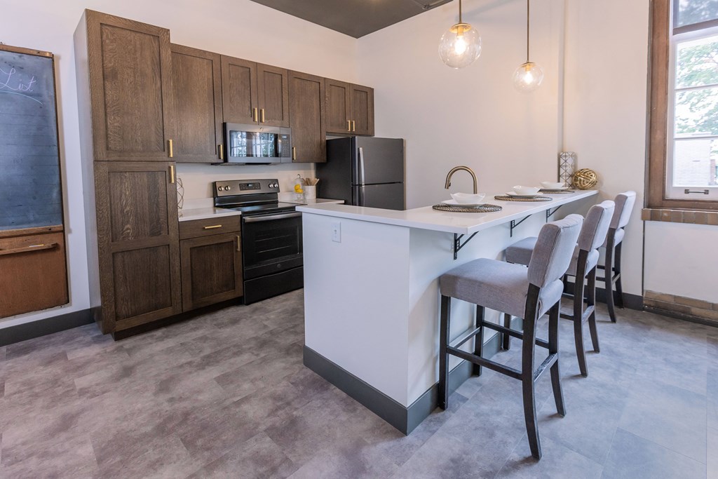 a kitchen with a island and a table with chairs