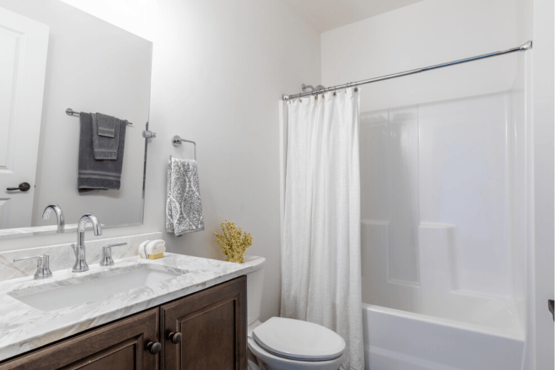 a bathroom with a shower and a sink and a toilet