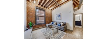 A living room with a grey couch and a coffee table.
