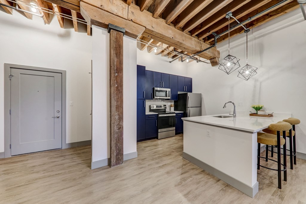 a kitchen with a white counter top and a sink