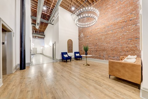 A room with a brick wall and a wooden floor.
