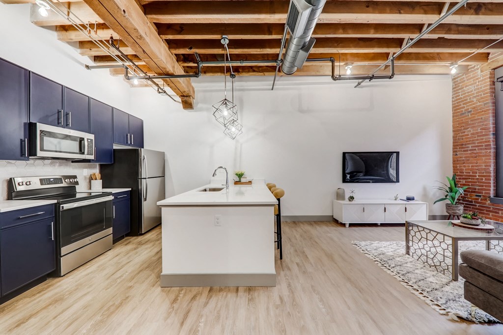 a living room with a kitchen and a tv