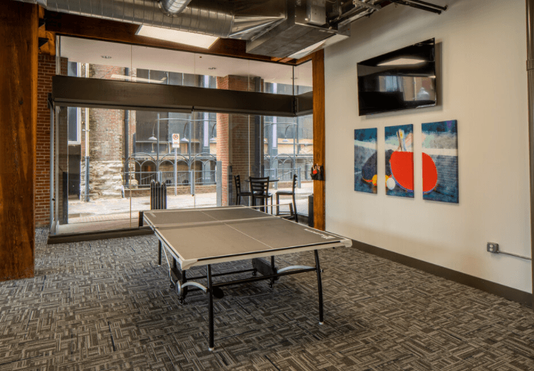a ping pong table in a room with a large window