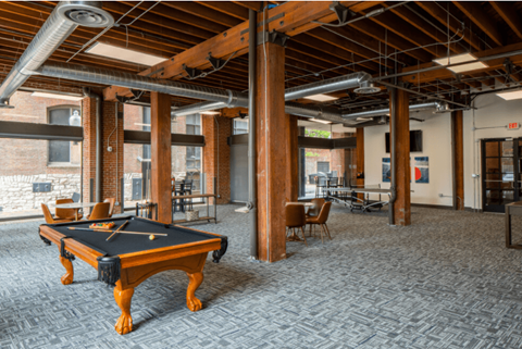 a room with a pool table in the center of it