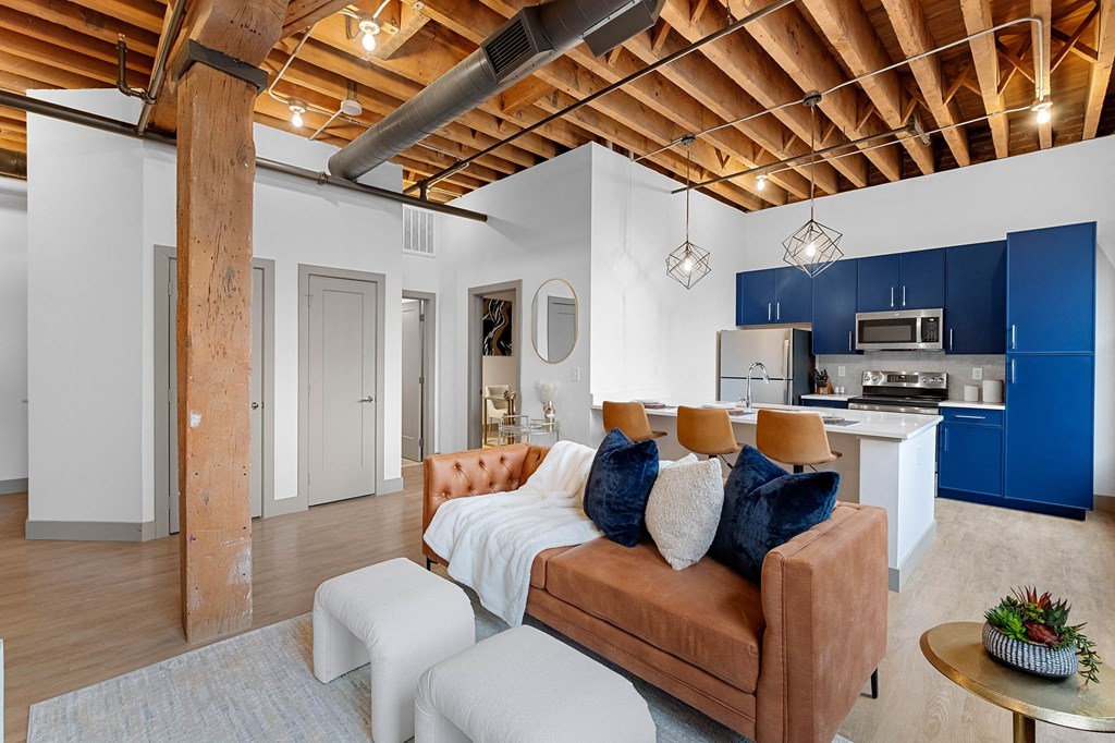 a living room with a couch and a kitchen