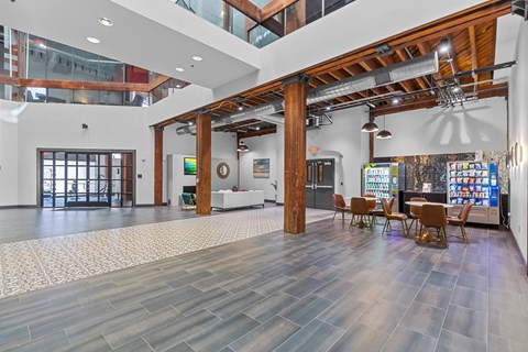 A spacious room with wooden floors and a high ceiling with a skylight.