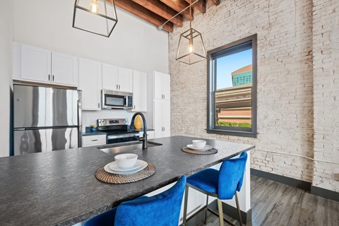 a kitchen with a counter top and a stainless steel refrigerator