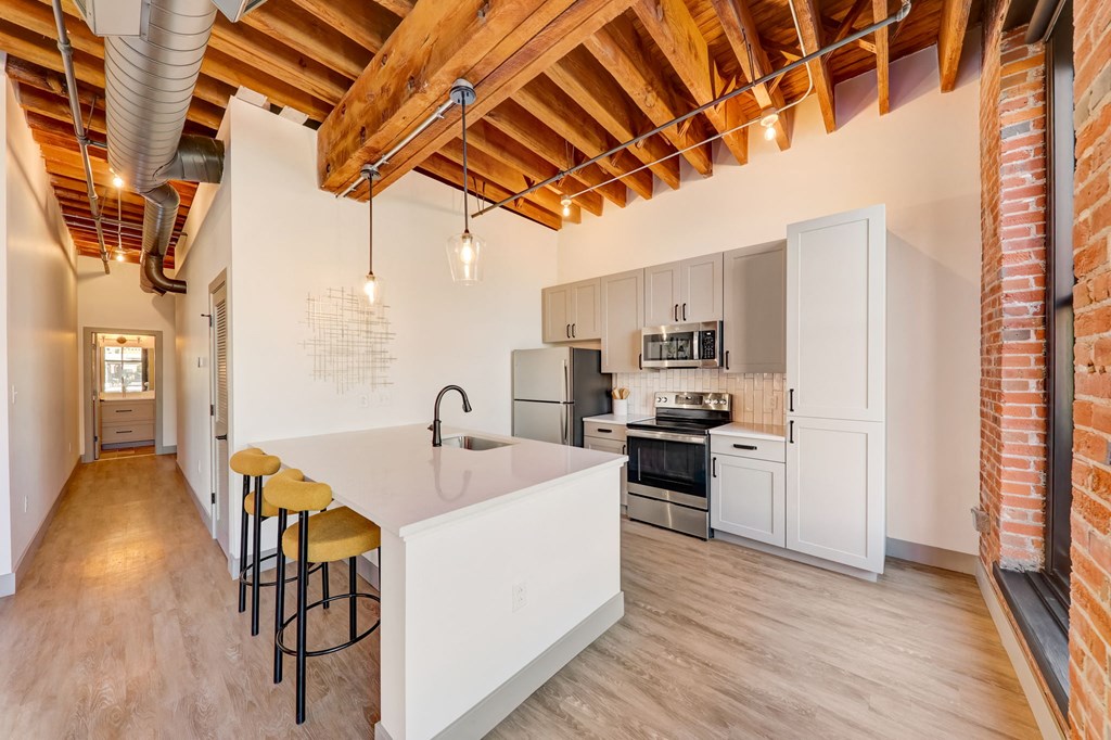 a kitchen with a white counter top and a sink at Greeley Lofts, St. Louis, 63102