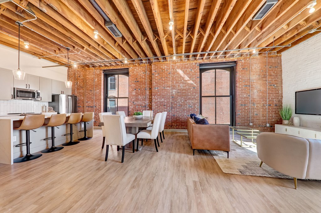 a living room and dining room with a table and chairs at Greeley Lofts, St. Louis, MO