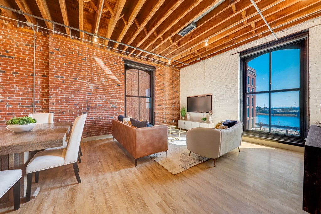 a living room with a couch and a table and a tv at Greeley Lofts, St. Louis, MO