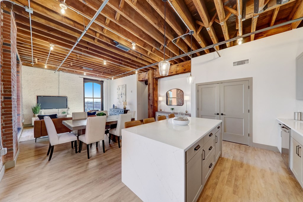 a kitchen with a large island and a dining room at Greeley Lofts, St. Louis
