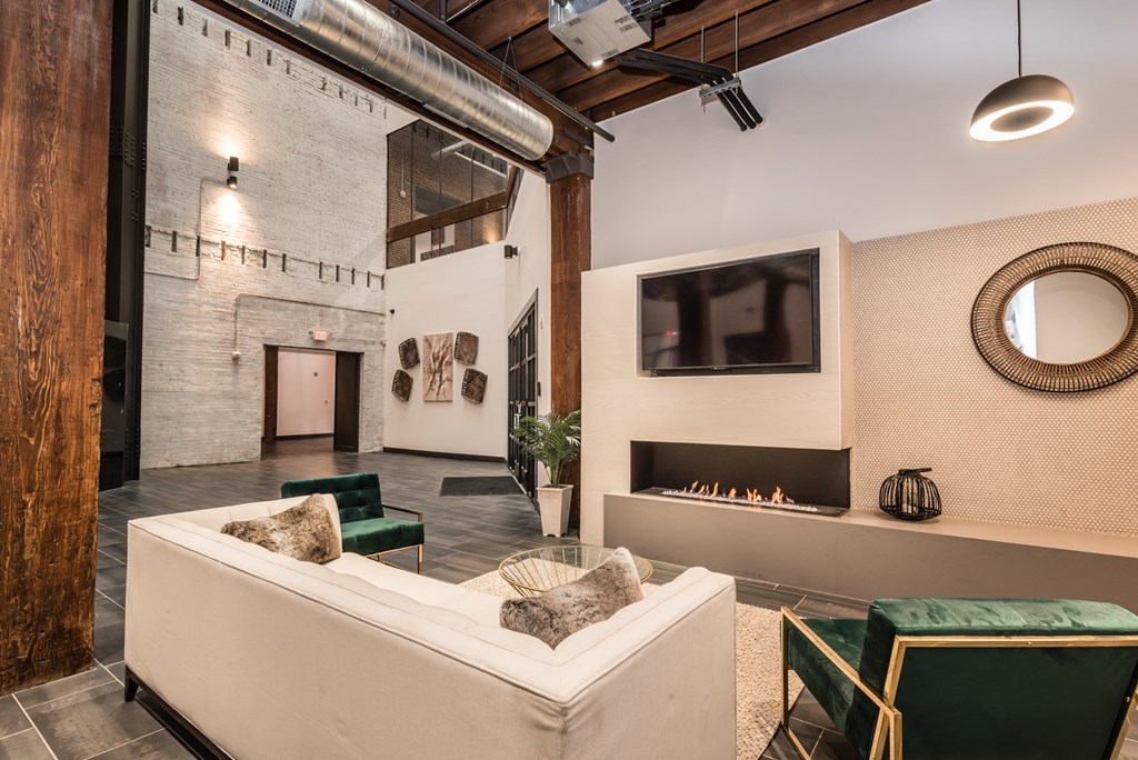 a living room with a white couch and a fireplace